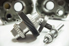 Close-up of mechanical gears and shafts on a white background