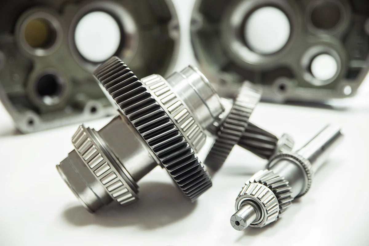 Close-up of mechanical gears and shafts on a white background