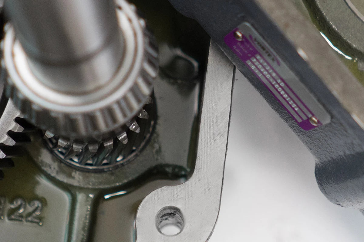 Close-up of a mechanical component with gears and metal parts.