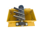 Mechanical component with a spring and metal parts on a yellow base against a white background